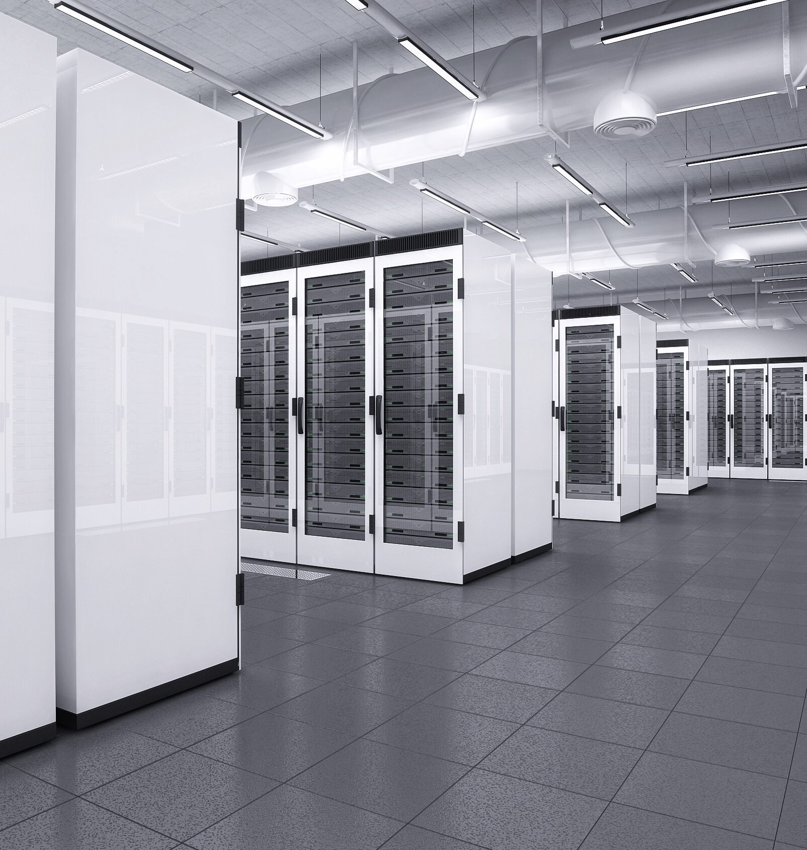 A modern data center interior with several server racks, white walls, and a reflective tiled floor, illuminated by ceiling lights.